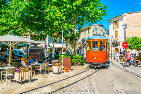 SOLLER, SPAIN, MAY 26, 2017:  Traditional red tram is passing through the center of Soller at Mallorca, Spainのeditorial素材