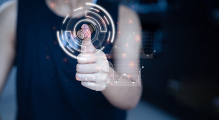 male hand touching a virtual holographic image. Choose an exercise program Going to the dumbbell Exercise ideas, maintain fitness, exercise monitoringの写真素材