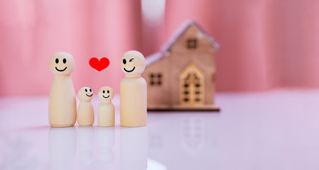 Happy family concept. Wooden figures of people with heart and house.の写真素材
