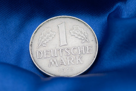 High Quality Macro of a Deutsche Mark Coin on Blue Background to sho Germany in the European Unionの写真素材