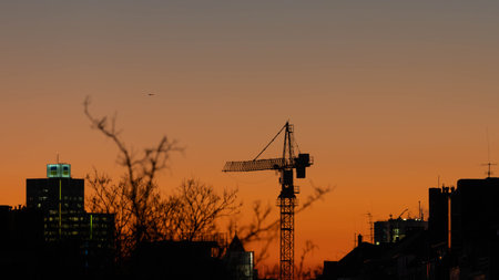 Crane in a fiery Sunset of Duesseldorf Germany in November 2025 - City Developmentの写真素材