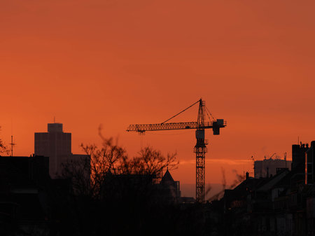 Crane in the fiery Red Sunset in November 2025 - City Developmentの写真素材