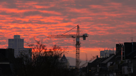 Crane in the fiery Red Sunset of Duesseldorf Germany in November 2025 - City Developementの写真素材