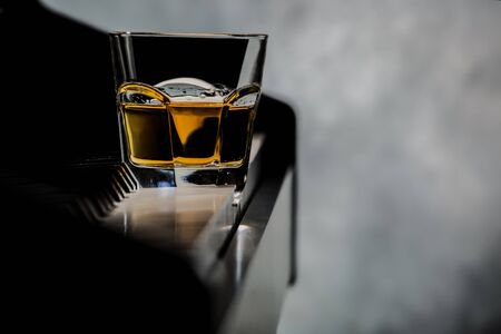 Glass of whiskey on the pianoの写真素材