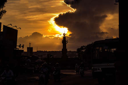 Silhouettes of people on the street at sunset in Bangkok, Thailand.