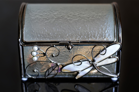 Glass casket with gold on a black backgroundの写真素材