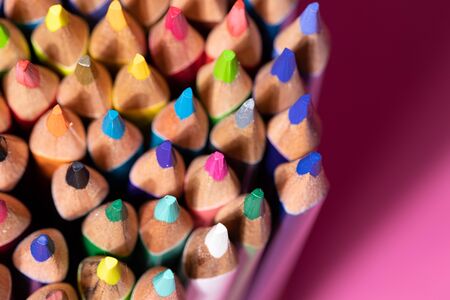 Big bunch of colorful pencils on pink background. Education, back to school concept with copy space