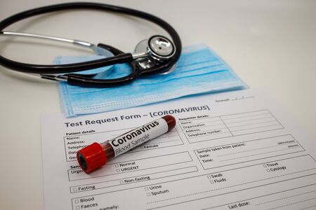 Blood sample for the new rapidly spreading Coronavirus . Test tube on an empty blood test request...