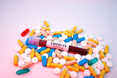 DUBAI, UAE - CIRCA 2020: Blood test tube for the new rapidly spreading Coronavirus, on a big pile of different type of medical pills.のeditorial素材