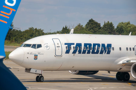Otopeni, Romania - Circa 2023: Tarom, the national operating airline of Romania, name on the front of the airplane.のeditorial素材