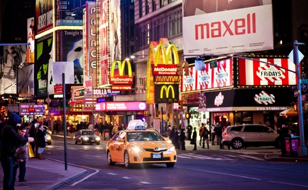 NEW YORK CITY - JAN 10: Yellow taxi car riding through Times Square on  January 10, 2011 in Manhattan, New York City.のeditorial素材