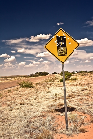 Road sign full of shotgun holes found at New Mexico, USAの写真素材