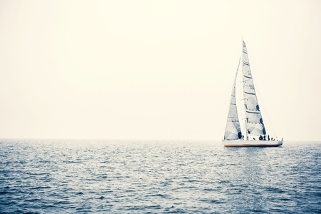 Sailing ship yachts with white sails in a row