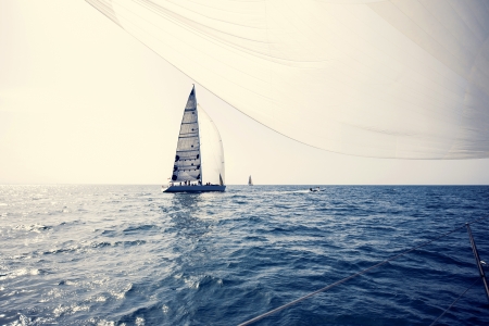 Sailing ship yachts with white sails in a rowの写真素材