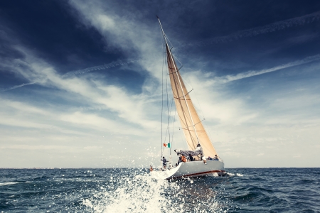 Sailing ship yachts with white sails in the open sea