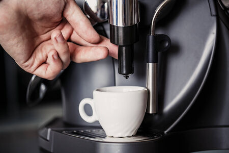 Closeup of Barista makes coffee with a machineの写真素材