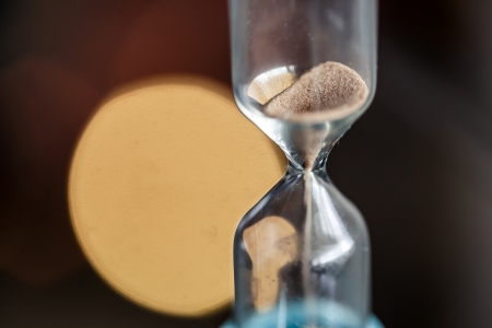 Closeup of Hourglass with pouring sandの写真素材