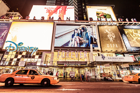 NEW YORK CITY - AUGUST 13: Times Square, is a busy tourist intersection of neon art and commerce and...