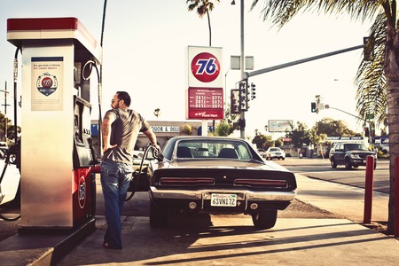 CALIFORNIA, USA - AUGUST 5, 2012: Man filling the car with gasoline in gas stations on August 5, 2012, San Diego, CA, USAのeditorial素材