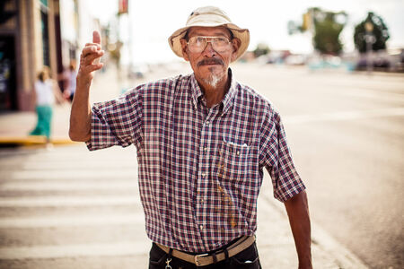 GALLUP, NEW MEXICO - AUGUST 04, 2013: Mature man in hat and glasses in Gallup on August 04, 2013, New Mexico, USAのeditorial素材