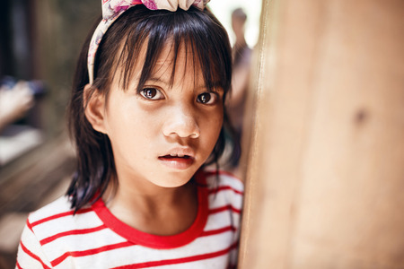 ANGKOR WAT,CAMBODIA - DECEMBER 31: Girl posing at sunset in Angkor Wat on December 31,2013,Cambodiaのeditorial素材
