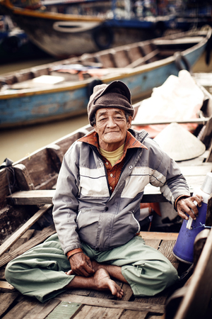 Old man on a boat in river, Vietnam.のeditorial素材