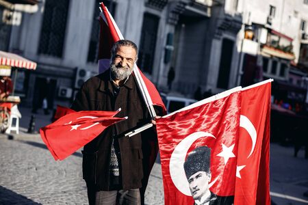 ISTANBUL, TURKEY - NOVEMBER 28: Unknown man sells turkish national flags, Istanbul, Turkey on November 28, 2014のeditorial素材