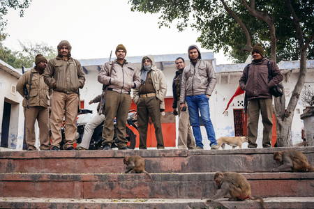 AGRA, INDIA - JANUARY 8, 2015: Indian men with weapon and monkeys on January 8, 2015 in Agra, Indiaのeditorial素材