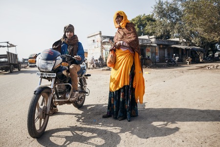 RAJASTHAN, INDIA - JANUARY 9, 2015: Men in traditional clothes with motorbike on January 9, 2015 in Rajasthan, Indiaのeditorial素材