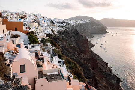 View of famous white buildings of Oia town on cliff in Santorini, Greeceの写真素材
