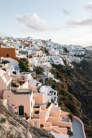 View of famous white buildings of Oia town on cliff in Santorini, Greeceの写真素材