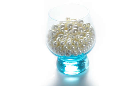 Blue glass with pearls on a white background isolateの写真素材