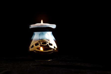 antique candlestick with two candles on velvet on a black background isolateの写真素材