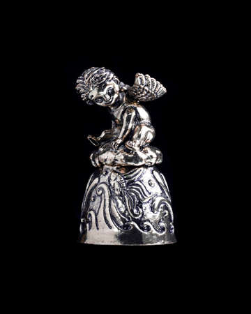 bell with an angel on a black background isolate