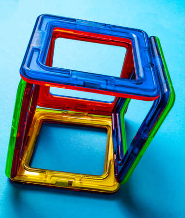 Children's toy constructor on magnets on a blue backgroundの写真素材