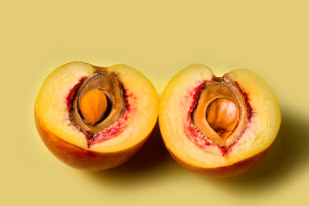 Nectarine, peach on a yellow background. copy spaceの写真素材