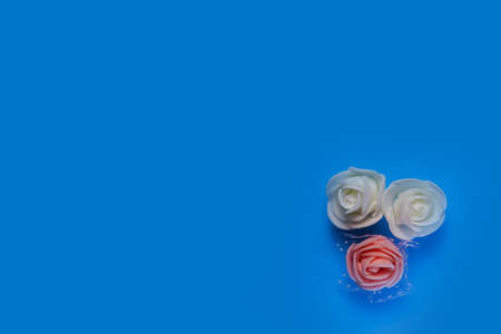 artificial flowers on a blue background frame for text. copy spaceの写真素材