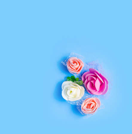 artificial flowers on a blue background frame for text. copy spaceの写真素材