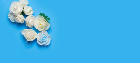 artificial flowers on a blue background frame for text. copy spaceの写真素材