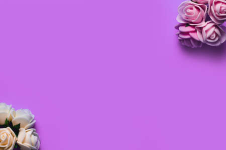 artificial roses on a blue background frame for text. copy spaceの写真素材