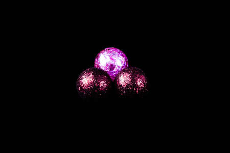 Three New Year's balls pink on a black backgroundの写真素材