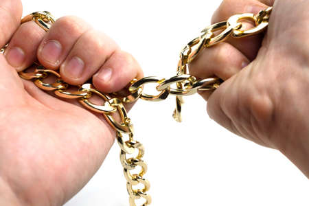 Golden chain in hands on a white background isolateの写真素材
