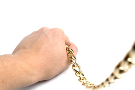 Golden chain in hands on a white background isolateの写真素材