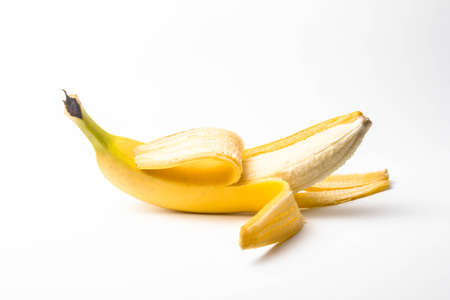 ripe yellow banana half peeled on a white background isolateの写真素材