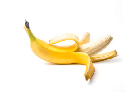 ripe yellow banana half peeled on a white background isolateの写真素材