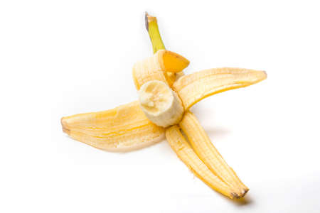ripe yellow banana half peeled and bitten on a white background isolateの写真素材