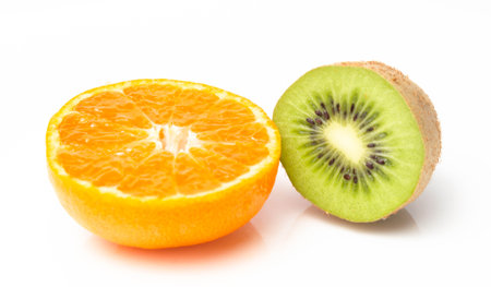 Orange mandarin and green kiwi on a white backgroundの写真素材