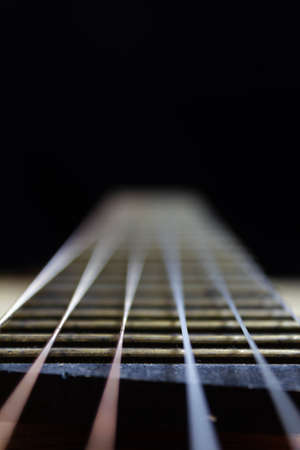 acoustic guitar strings on black backgroundの写真素材