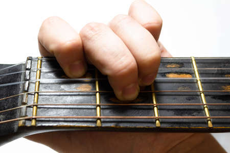 finger chords acoustic guitar on white backgroundの写真素材