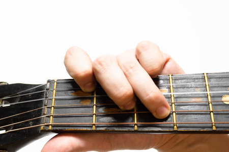 finger chords acoustic guitar on white backgroundの写真素材